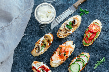 Bruschetta with mushrooms, cucumbers, avocado, radish, salmon and egg