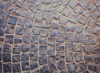 Dirty paving stones in the city. Road from paving stones for background and texture.