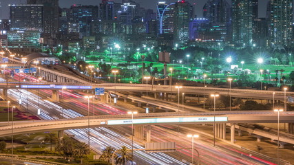 Fototapeta na wymiar Dubai Golf Course with a cityscape of Gereens and tecom districts at the background aerial night timelapse