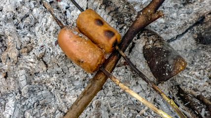 Grilled sausages on a bonfire on skewers