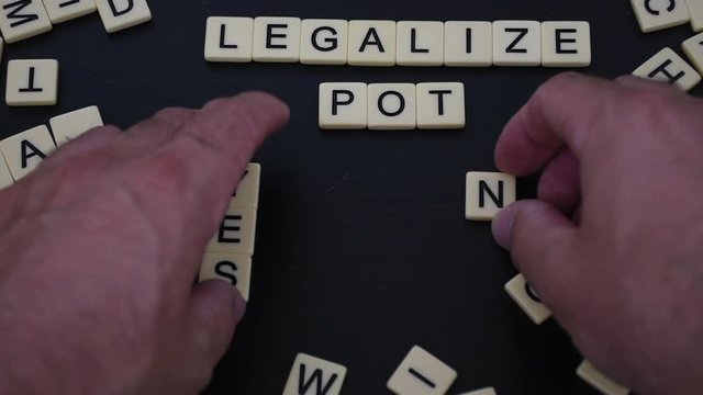 The debate to legalize marijuana, weed, or pot is an ongoing issue in Canada and United States. The decision for lawmakers is yes or no. Political and drug concept.