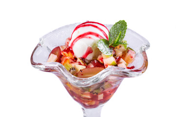 Apple, kiwi, orange, grapes and pear, served with a ball of ice cream