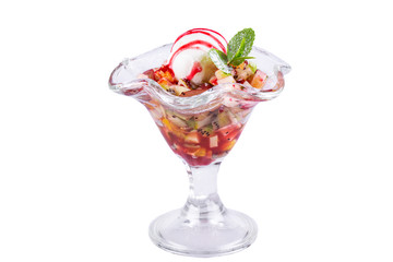 Pieces of fruit, served with a ball of vanilla ice cream