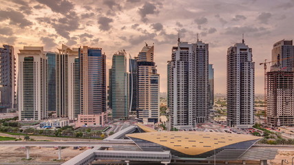 Naklejka premium Aerial top view to Sheikh Zayed road during sunrise near Dubai Marina and JLT timelapse, Dubai.