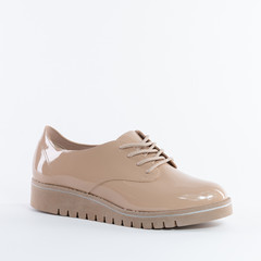 Beautiful patent leather women's shoes in beige. flat sole On white background. Choose other angles of this boot and new models in my profile