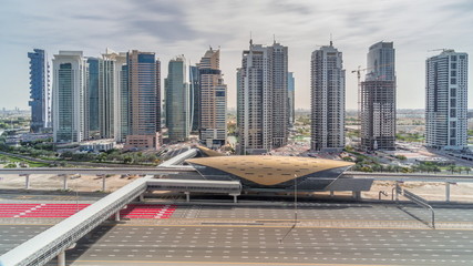 Naklejka premium Aerial top view to Sheikh Zayed road from Dubai Marina with JLT skyscrapers timelapse during all day, Dubai.