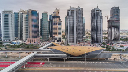 Naklejka premium Aerial top view to Sheikh Zayed road from Dubai Marina with JLT skyscrapers timelapse during all day, Dubai.