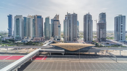Fototapeta na wymiar Aerial top view to Sheikh Zayed road from Dubai Marina with JLT skyscrapers timelapse during all day, Dubai.