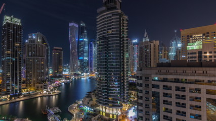 Obraz na płótnie Canvas Aerial view of Dubai Marina residential and office skyscrapers with waterfront night timelapse