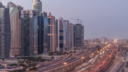 Fototapeta premium Aerial top view to Sheikh Zayed road near Dubai Marina and JLT night to day timelapse, Dubai.
