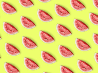 Pieces of ripe juicy watermelon on a light yellow background. Summer bright positive concept. Creative pattern, minimalism, top view, flat lay. Tasty and healthy food. C
