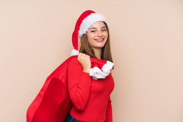 Young girl with christmas hat over isolated background