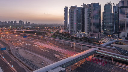 Fototapeta premium Aerial top view to Sheikh Zayed road near Dubai Marina and JLT night to day timelapse, Dubai.