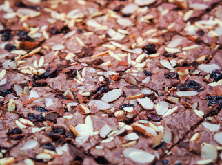 Close up of chocolate brownies mixed with almond nuts and raisins. Chocolate brownies for meal buffet or banquet events.