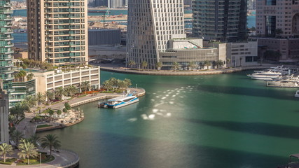 Naklejka premium Aerial view of Dubai Marina residential and office skyscrapers with waterfront timelapse