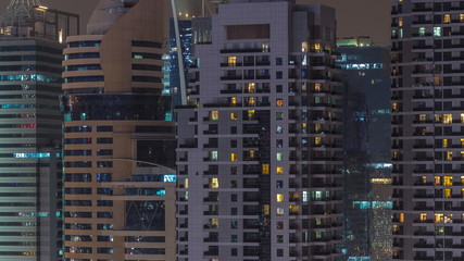 Fototapeta na wymiar Residential and office buildings in Jumeirah Lake Towers aerial night timelapse in Dubai, UAE.