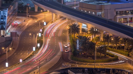 Aerial view to Dubai marina street with construction site on background night timelapse.