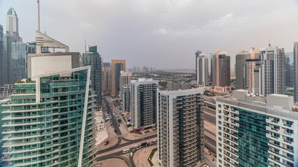 View of various skyscrapers and towers in Dubai Marina from above aerial timelapse