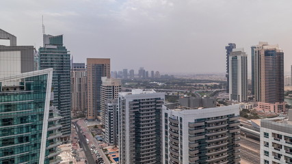 Fototapeta na wymiar View of various skyscrapers and towers in Dubai Marina from above aerial timelapse