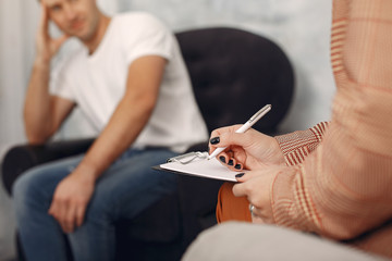 In the psychologist's office. Man and woman talking