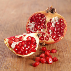 juicy pomegranate on wood background