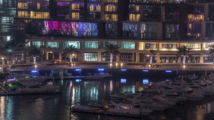 Waterfront promenade in Dubai Marina aerial night timelapse. Dubai, United Arab Emirates