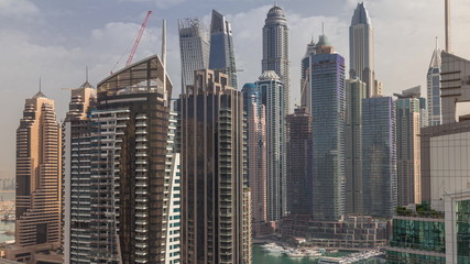 View of various skyscrapers and towers in Dubai Marina from above aerial timelapse