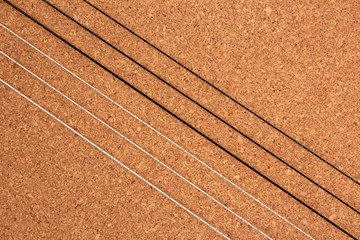 Classical guitar strings on balsa wood texture background