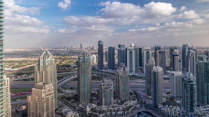 Fototapeta premium Dubai Marina skyscrapers and jumeirah lake towers view from the top aerial timelapse in the United Arab Emirates.