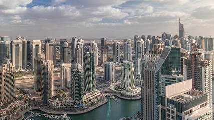 Obraz premium Dubai Marina skyscrapers and jumeirah lake towers view from the top aerial timelapse in the United Arab Emirates.