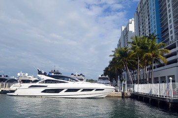 Fototapeta na wymiar Luxury motor yacht moored at a condo marina complex in southeast Florida