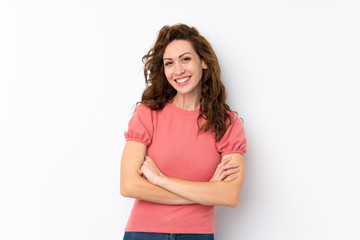 Young pretty woman over isolated background keeping the arms crossed in frontal position