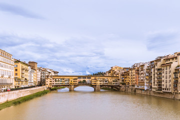 Cityscape with the famous  Goldsmiths Bridge across the Arno river under the blue sky.. Firenze, Tuscany, Italy.