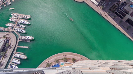 Dubai Marina harbor with modern yachts aerial timelapse