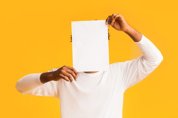 Man covering his face with empty white paper