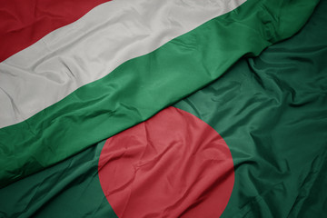 Obraz premium waving colorful flag of bangladesh and national flag of hungary.