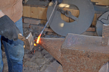 The work of a blacksmith. Creating a horseshoe in the old tradition
