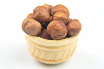 Different nuts in a waffle basket on a white background. Vitamin wholesome food.