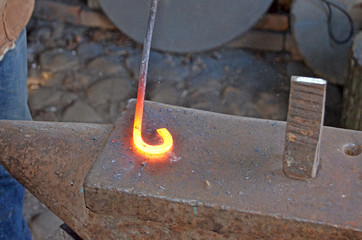 The work of a blacksmith. Creating a horseshoe in the old tradition