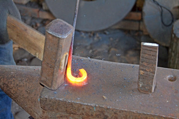 The work of a blacksmith. Creating a horseshoe in the old tradition