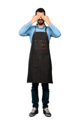 Full-length shot of Man with apron covering eyes by hands over isolated white background