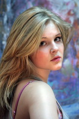 Portrait of a natural blonde. Teen girl on a colorful background