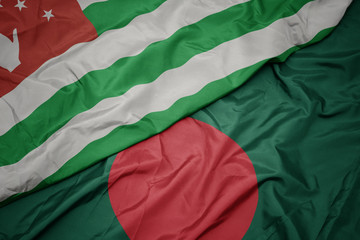 waving colorful flag of bangladesh and national flag of abkhazia.