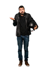 Naklejka premium Full-length shot of Biker man making doubts gesture over isolated white background