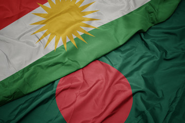 waving colorful flag of bangladesh and national flag of kurdistan.