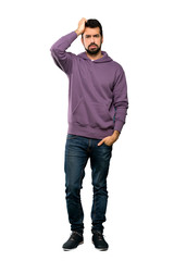 Full-length shot of Handsome man with sweatshirt with an expression of frustration and not understanding over isolated white background