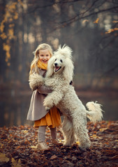 Girl with a dog in an autumn park