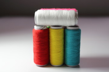 Sewing cotton line on white background. Space for copy, insert text. Metaphor with political position, teamwork, feelings, emotions, decision. 