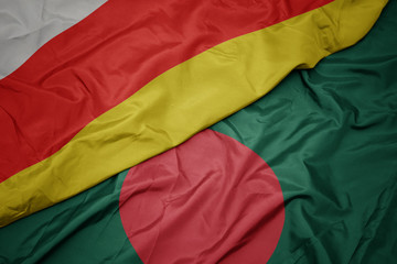 waving colorful flag of bangladesh and national flag of south ossetia.