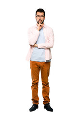 Fototapeta premium Full-length shot of Handsome man with beard showing a sign of silence gesture putting finger in mouth over isolated white background